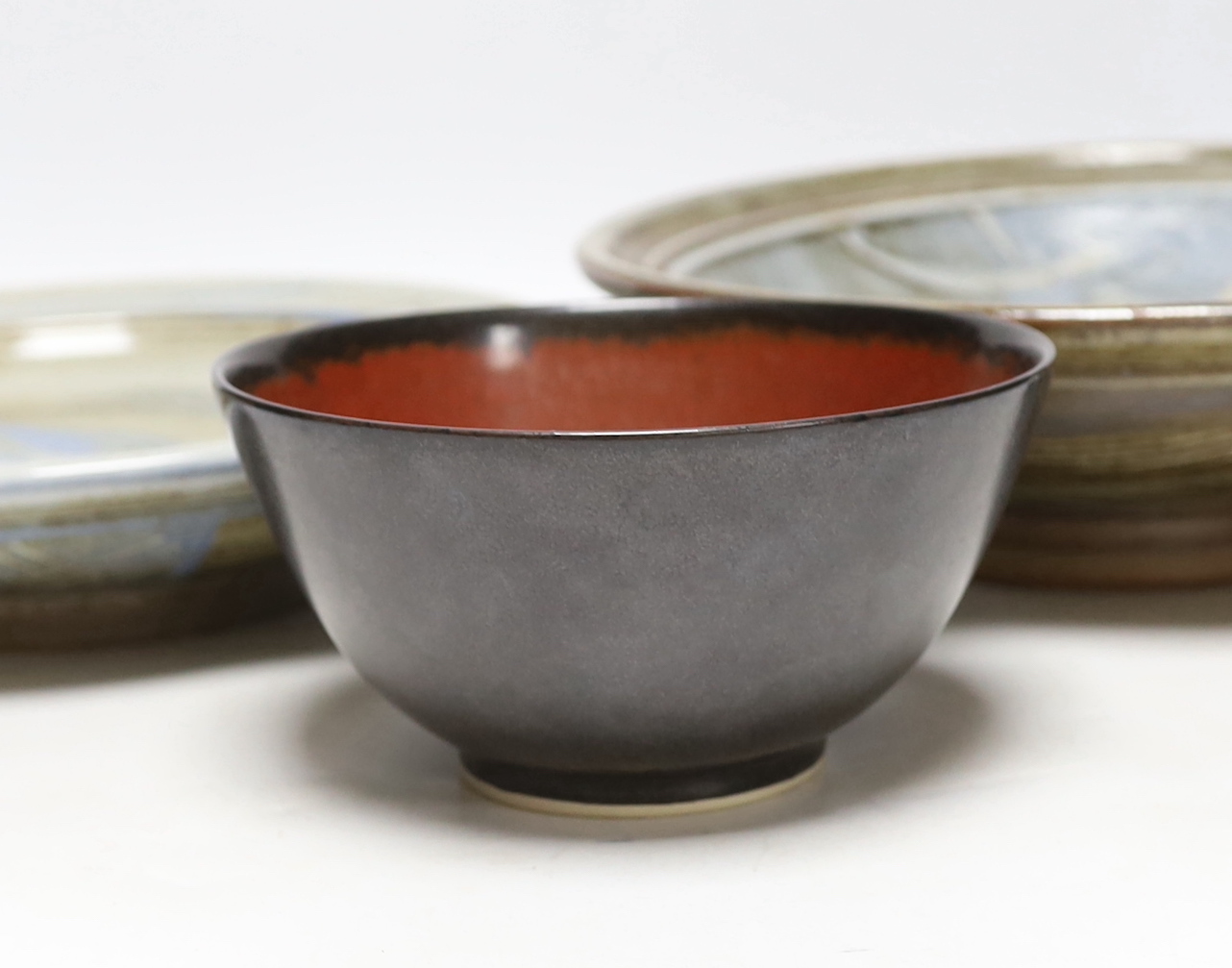 A bowl by Suleyman Saba, Australia and two shallow pottery bowls, largest diameter 28cm